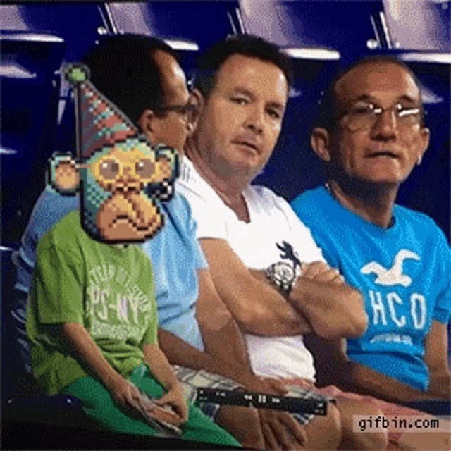 a man wearing a hollister shirt is sitting next to a boy wearing a pixelated monkey mask