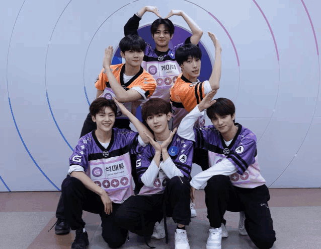 a group of young men are posing for a picture with one wearing a shirt that says ' s ' on it