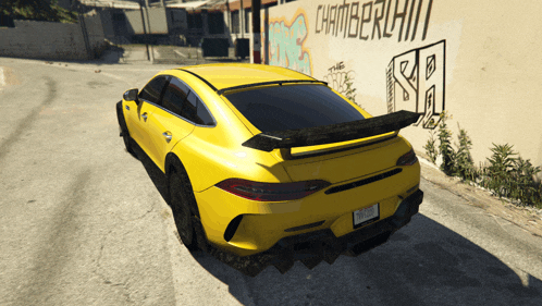 a yellow car is parked in front of a wall that has the word chamberlain on it