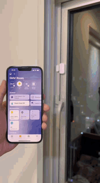 a person is holding a smart phone with the girls room app open