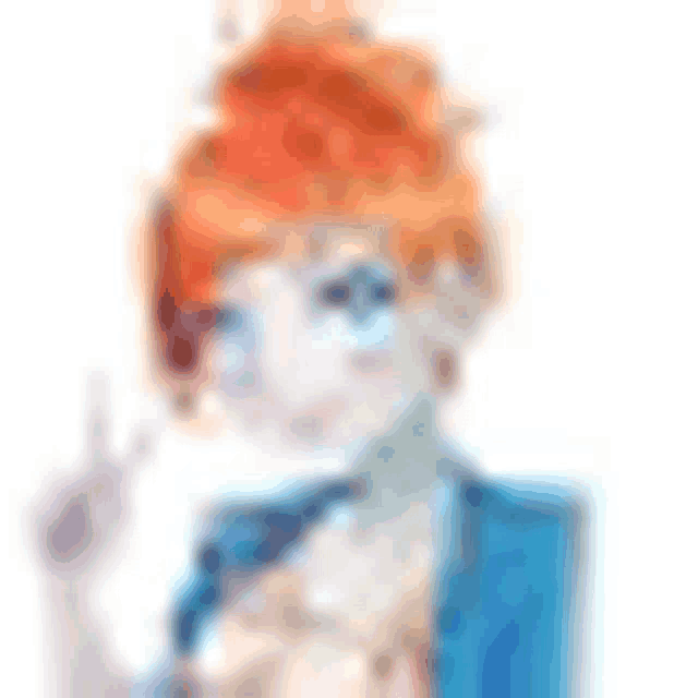 a blurred image of a girl with red hair and blue eyes giving a peace sign .