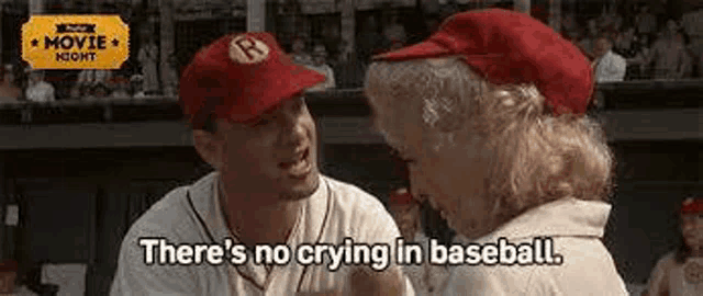 a man and a woman are sitting next to each other in a baseball dugout .