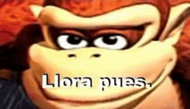 a close up of donkey kong 's face with the words `` llora pues '' written in the corner .