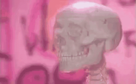 a skeleton is standing in front of a pink background .