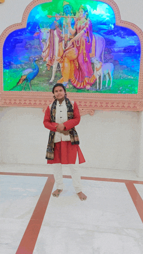 a man standing in front of a painting of krishna