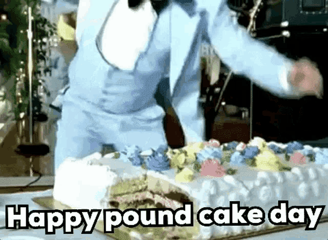 a man in a suit is cutting a large cake with the words `` happy pound cake day '' written on the bottom .