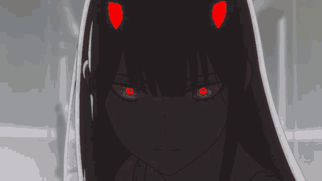 a girl with red horns on her head looks at the camera