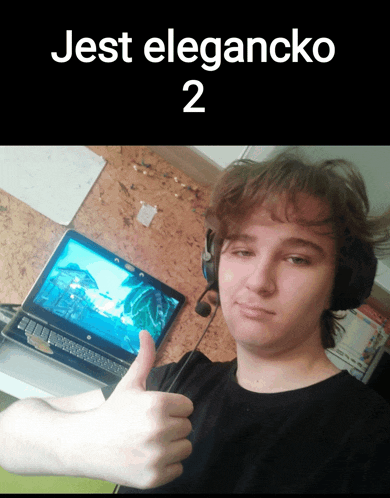 a young man giving a thumbs up in front of a laptop with the words jest elegancko 2 below him