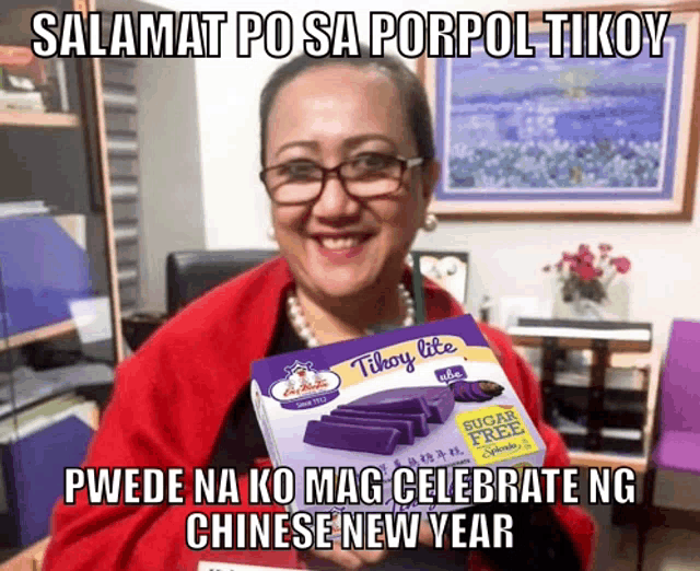 a woman is holding a box of tilhoy lite purple cake