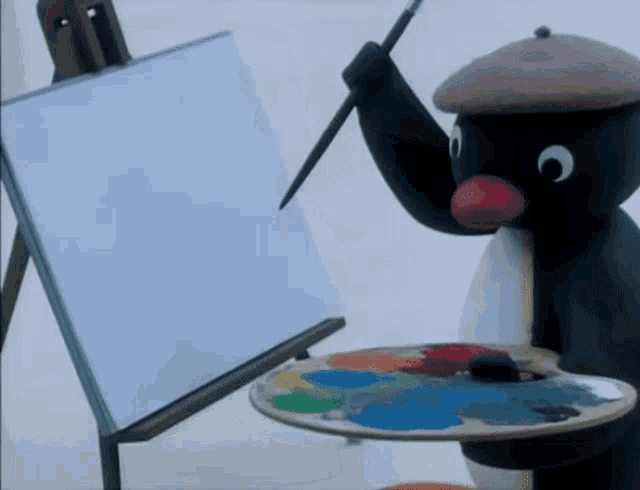 a penguin is holding a brush in front of a white board