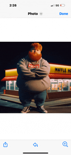 a fat man with a beard wearing a supreme hoodie is standing in front of a waffle house