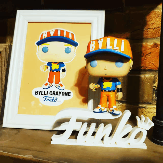 bylli crayone funko pop in front of a framed picture