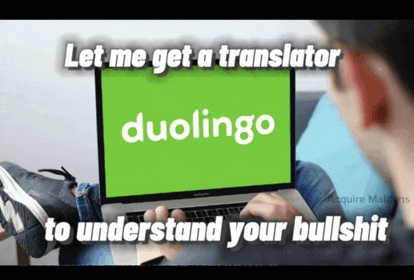 a man is using a laptop with the word duolingo on it