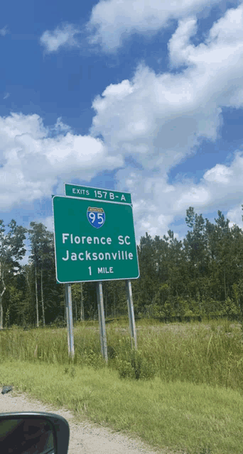 a green highway sign that says exits 157b-a florence sc jacksonville