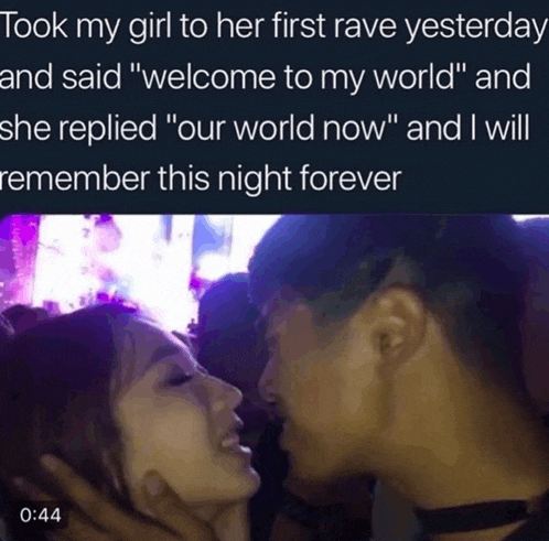 a man and a woman are kissing at a rave