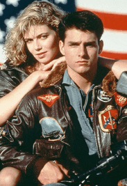 a man and a woman are posing for a picture and the man is wearing a leather jacket with the letter l on it