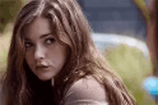 a close up of a woman 's face with long hair .