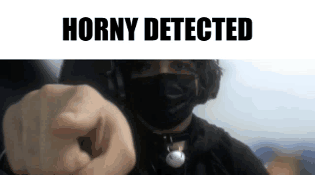 a man wearing a mask is pointing at the camera with the words horny detected behind him