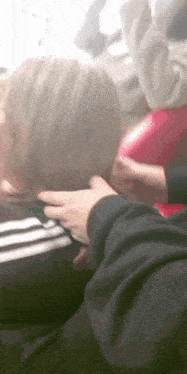 a person putting their hand on another person 's back