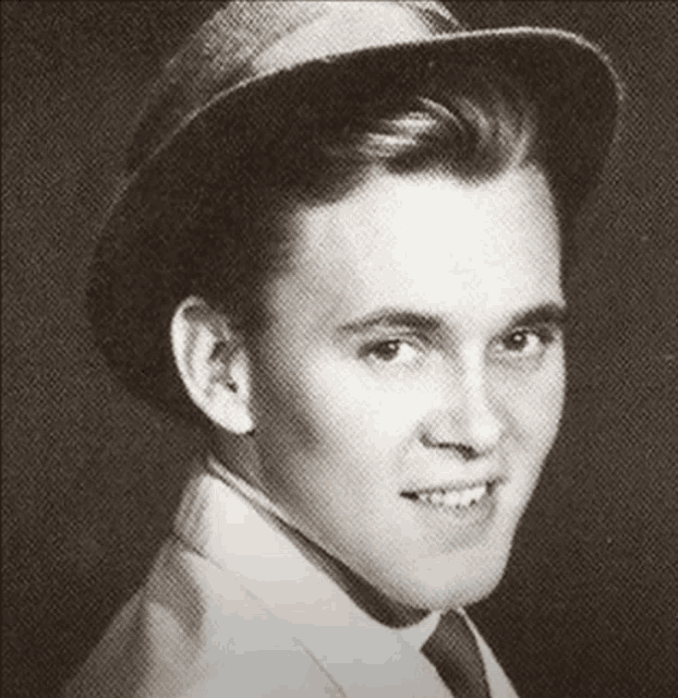 a young man wearing a hat and smiling for the camera