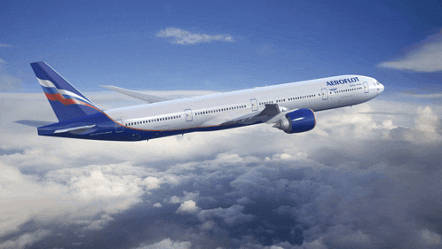 a blue and white aeroflot airplane flies through the clouds