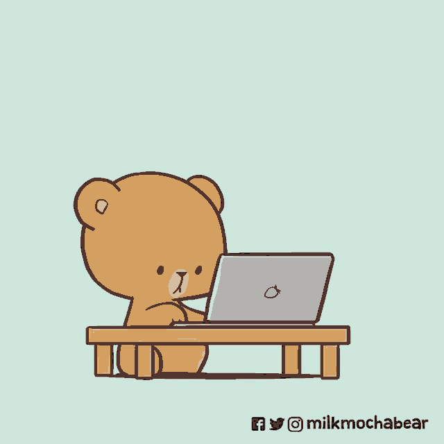 a teddy bear is sitting at a table using a laptop computer