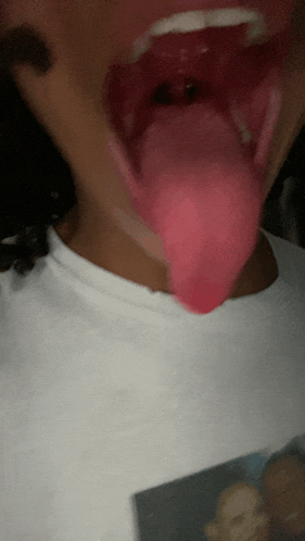 a close up of a person 's mouth with their tongue out