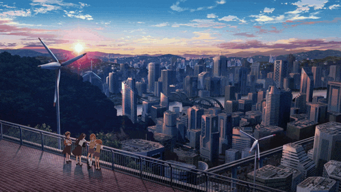 a group of people are standing on a balcony overlooking a city