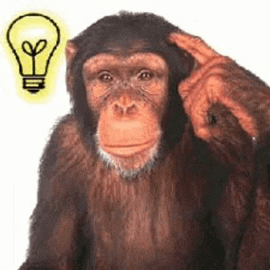 a chimpanzee is scratching his head with his finger in front of a light bulb .