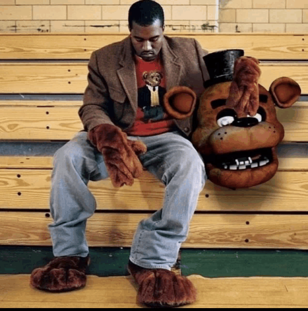 a man is sitting on a wooden bench next to a stuffed foxy bear