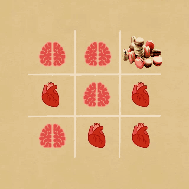 a tic tac toe game with brains and hearts and a pile of macaroons