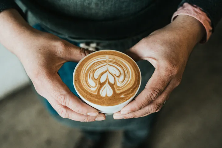 person holding a cup of coffee