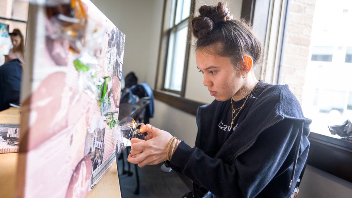 Kailee Tomas uses a lighter to melt plastic litter collected from the Mohawk River watershed.