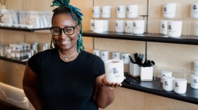 Joi Riley, of J.R. Candle Co., holds one of her candles on Wednesday, Oct. 23, 2024, at the Eric Outlaw Business Center incubator cohort.