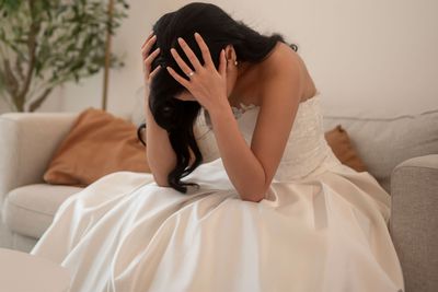 Sad and worried bride crying and arguing with groom in wedding day