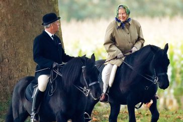 Queen Elizabeth II, accompanied by her Stud Groom Terry Pendry, seen horse riding in the grounds of Windsor Castle on October 18, 2008 in Windsor, England. 