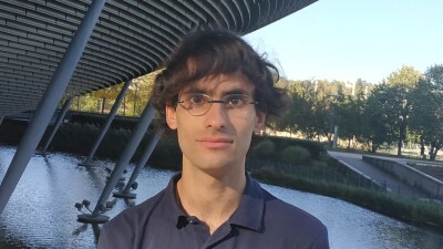 Vincent Lequertier standing in front of a river and a bridge