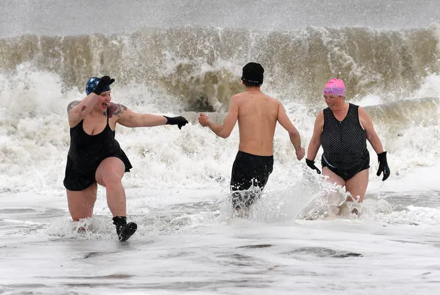 Despite the high winds and fright temperatures, about 1/2 dozen brave members of the Coney Island Polar Bear Club took a dip in the Atlantic Ocean at March 14, 2017, just of Stillwell avenue in Coney Island beach in Brooklyn NYC. Snow began blanketing northeastern United States on Tuesday as a winter storm packing blizzard conditions rolled into the region, prompting public officials to ask people to stay home while airlines grounded flights and schools canceled classes. The National Weather Service issued blizzard warnings for parts of eight states including New York, Pennsylvania, New Jersey and Connecticut, with forecasts calling for up to 2 feet of snow by early Wednesday, with temperatures 15 to 30 degrees below normal for this time of year. (Photo by Paul Martinka)