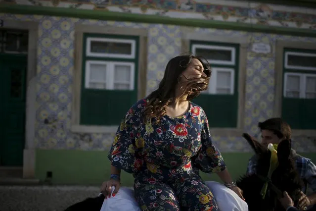 A woman takes part in the procession of the “Virgem da Atalaia” procession during Holy Week at Alcochete, near Lisbon, Portugal March 27, 2016. (Photo by Rafael Marchante/Reuters)