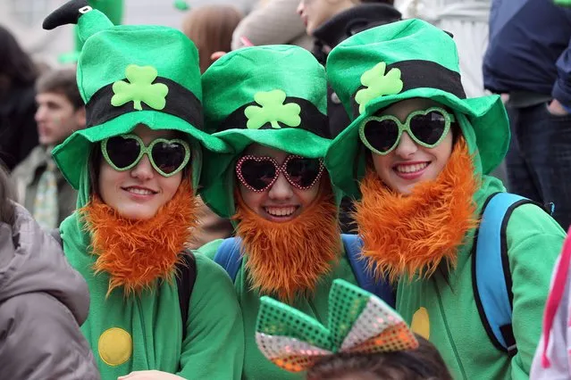 Spectators dressed as leprechauns attend St Patrick's Day parade in Dublin on March 17, 2014. (Photo by Peter Muhly/AFP Photo)