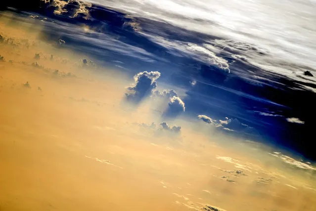 Image of the Clouds taken in August 2014 by astronauts on board the International Space Station (ISS).  A year from space photographs of hurricanes, typhoons and meteorite craters show an astronauts-eye view of our planet from hundreds of miles above the earth. The illuminating images were taken by astronauts onboard the International Space Station (ISS) over the course of 2014. (Photo by NASA/SPL/Barcroft Media)