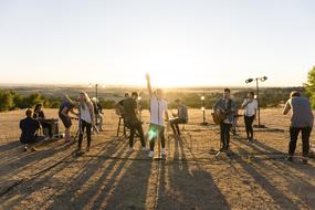 music band, young Girls and Guys performing in countryside