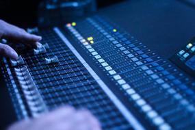 hands and audio console in studio