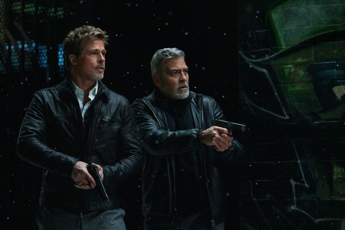 Pam's Man (Brad Pitt, L) and Margaret's Man (George Clooney) go after the drugs, in "Wolfs." (Apple Original Films)