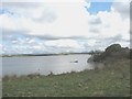 SH3277 : Llyn Traffwll with the mountains of Snowdonia in the background by Eric Jones