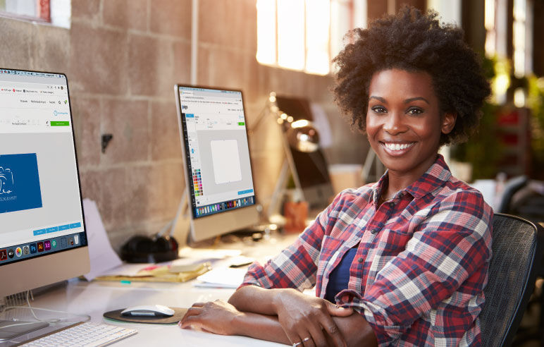 Graphic designer sitting behind her desk and smiling