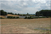  : New farm buildings partially concealed by a shallow valley by Mike Hallett