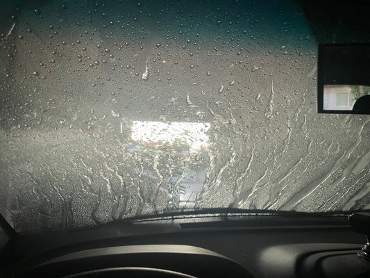 Photo of Chevron - Fremont, CA, US. a car's windshield covered in rain