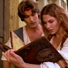 Maeve reading a mystic tome while Sinbad looks over her shoulder