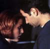 Fox Mulder and Dana Scully hugging each other, forehead against forehead